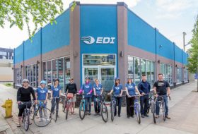 Group of cyclists outside of the place they work