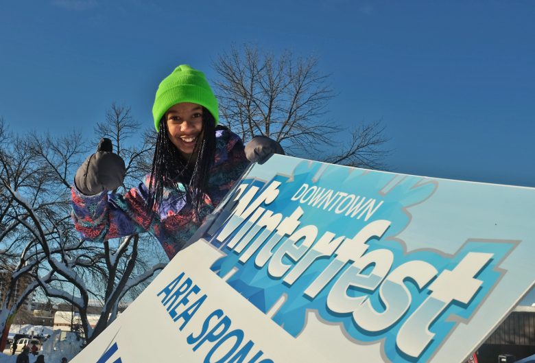 Girl with Winterfest sign