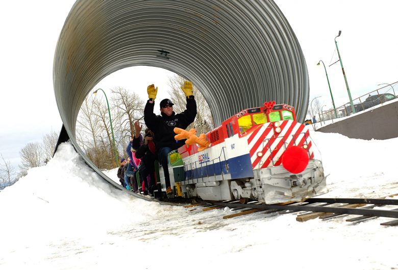 People riding a mini train