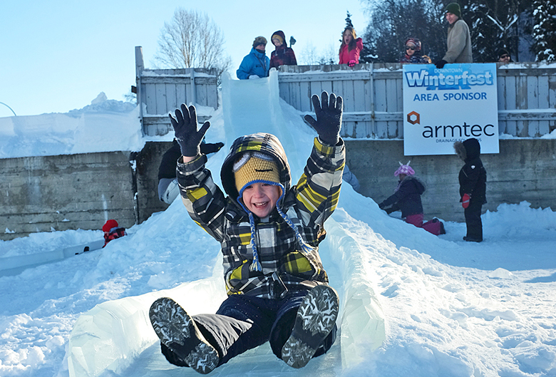 Child sliding down an ice slide