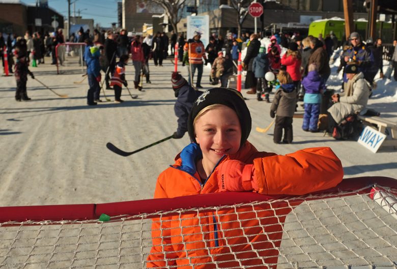 Kids playing road hockey