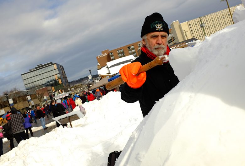 Man carving snow sculpture