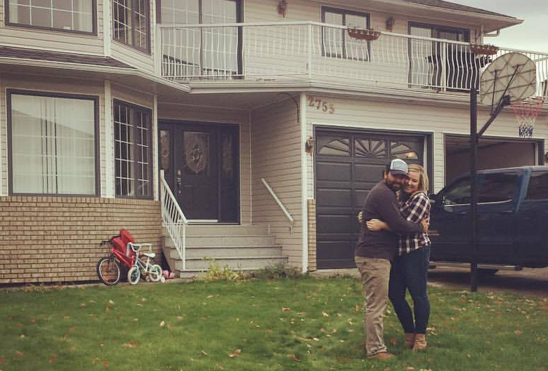 Stephanie and her husband outside their house