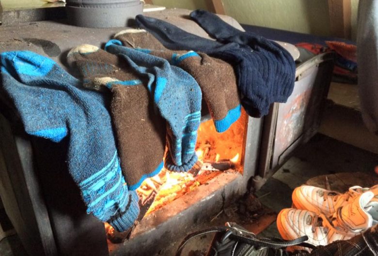 Socks drying on a wood stove