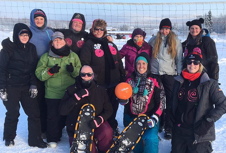 people with volleyball and snowshoes in snow