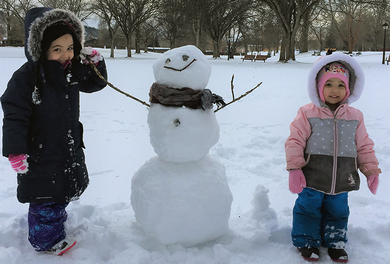 two girls and a snowman