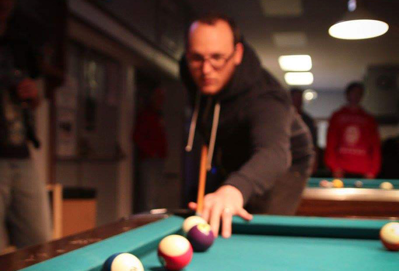 man playing pool