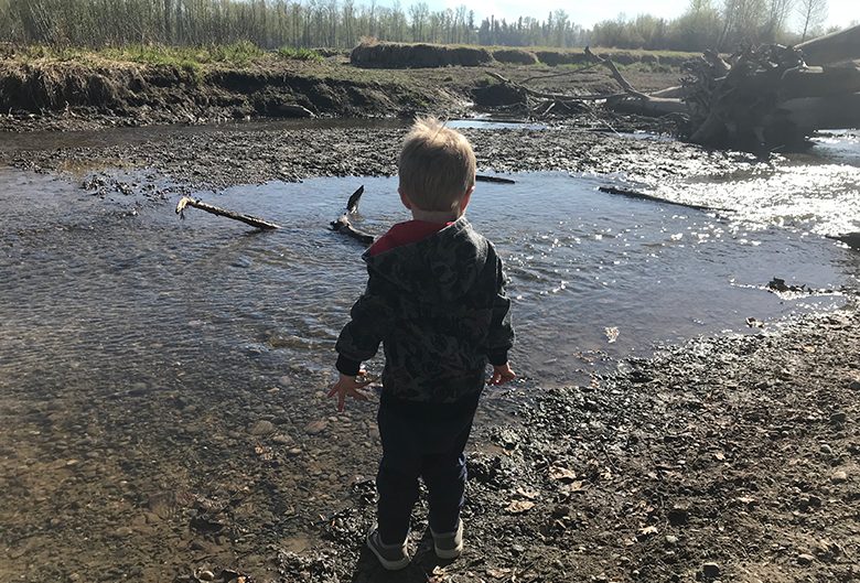 boy standing by water