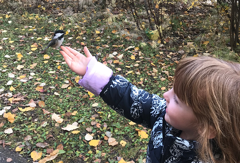 girl with chickadee