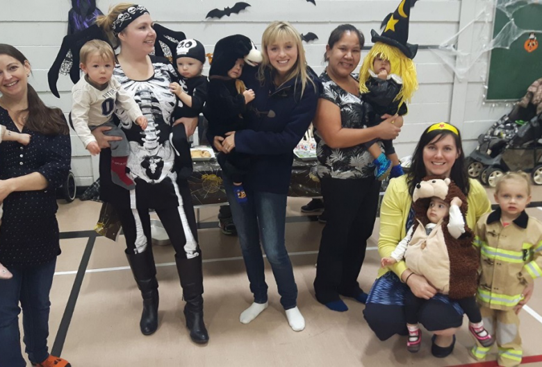 women and kids in Halloween costumes