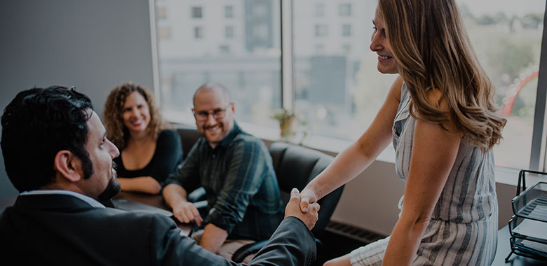 Office workers shaking hands