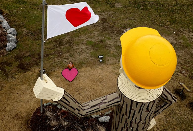 woman holding heart by Mr. PG holding heart flag