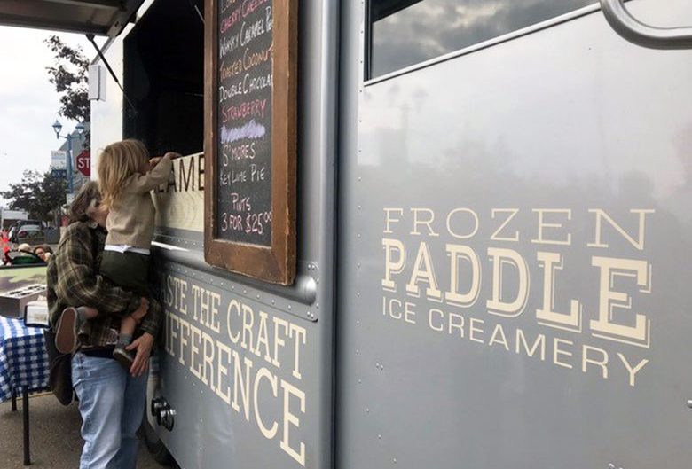 girl getting ice cream from ice cream truck