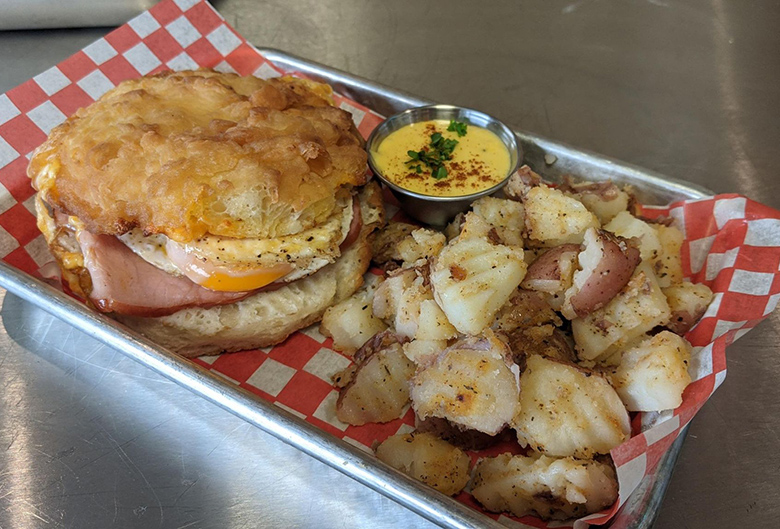 Egg and ham on English muffin and hashbrowns.