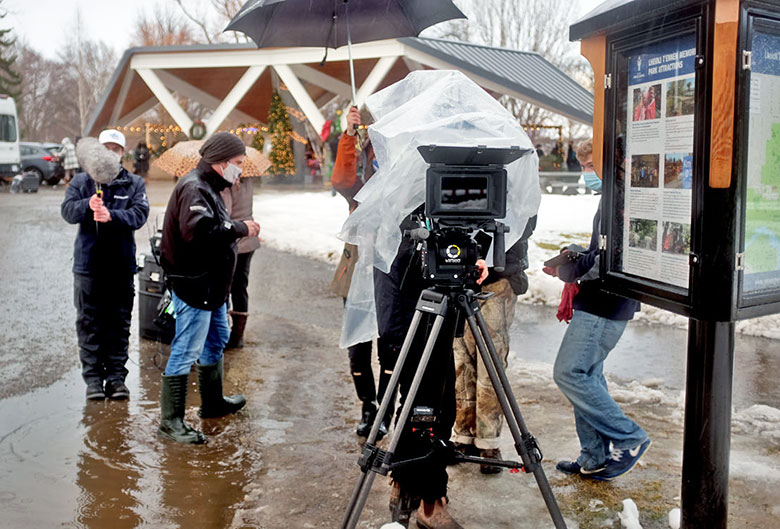 Film crew in a park.