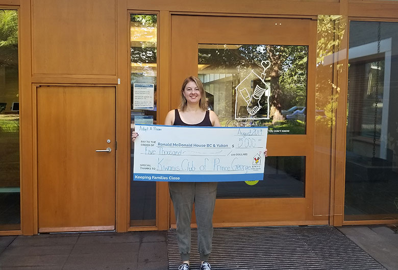 Woman holding a cheque.