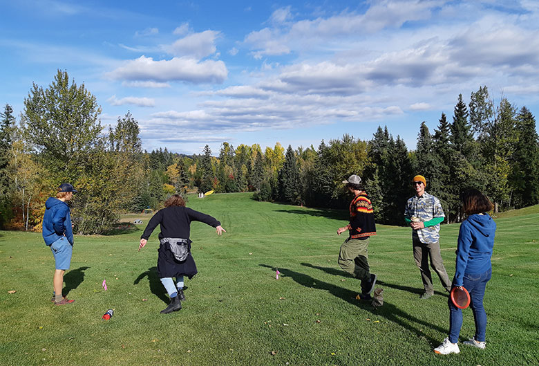 Students playing disc golf