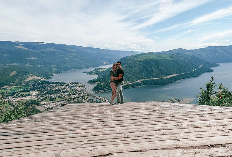 Couple posing on lookout.