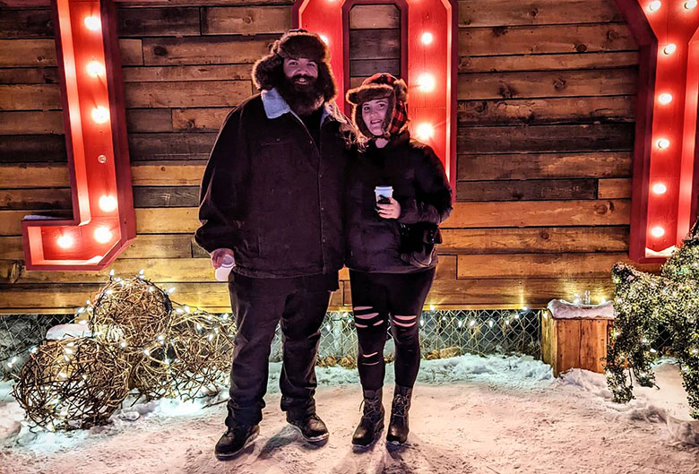 Couple in front of JOY sign