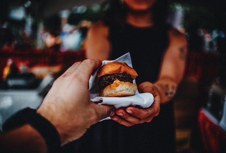 Hamburger being handed to person